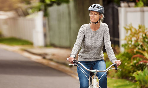 A senior woman riding a bicycle. fit mature lady living a healthy lifestyle enjoying a bike ride