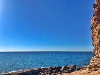 Scenic view of sea against clear blue sky