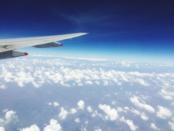 Aerial view of airplane flying in sky