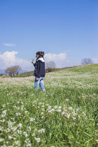 Full length of man standing on field against sky