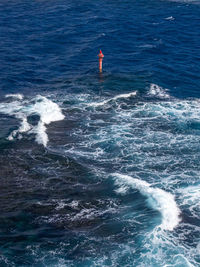 Rear view of man standing in sea