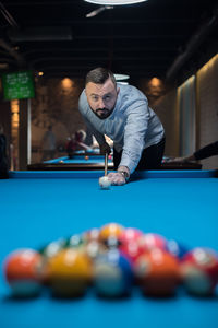 Man playing with ball on table
