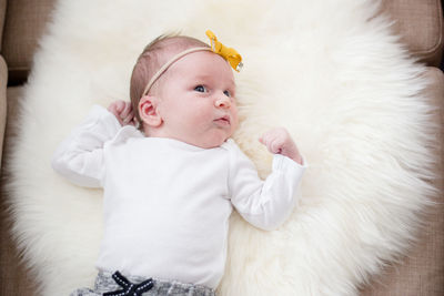 Cute baby lying on blanket at home