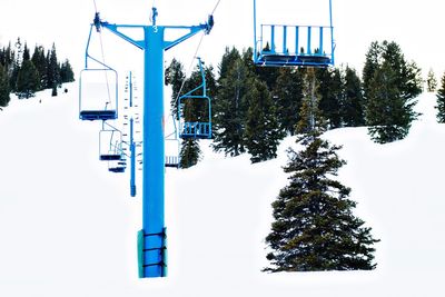 Low angle view of blue ski lift over snow