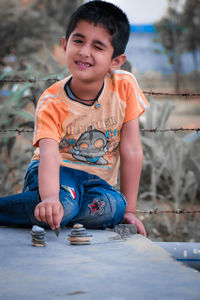 Portrait of boy sitting outdoors