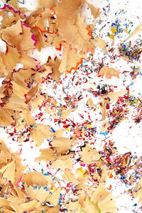 High angle view of multi colored pencils on white background
