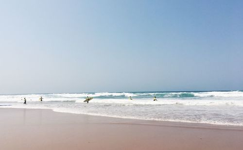 Scenic view of beach against clear sky