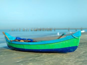 Boats moored on sea against blue sky