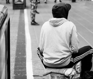 Rear view of man sitting outdoors