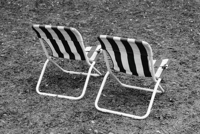 High angle view of empty chairs on field