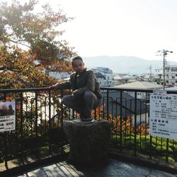 Portrait of young man standing against plants