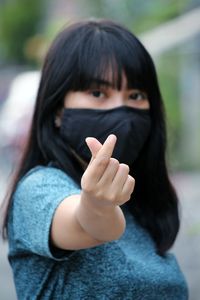 Portrait of a young woman covering face