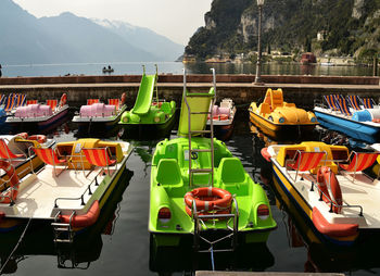 Pedal boats at harbor in lake garda