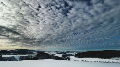 Scenic view of landscape against sky during winter