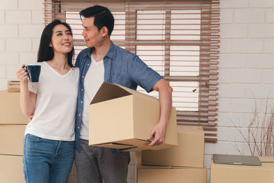 Young couple holding hands in box