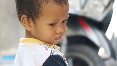 Close-up of cute baby boy looking down