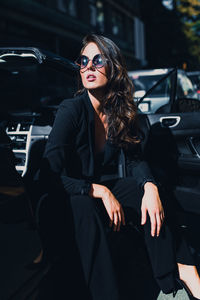 Young woman sitting in car