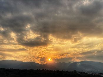 Scenic view of silhouette mountains against sky at sunset