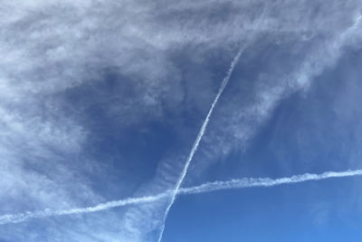 Low angle view of vapor trail