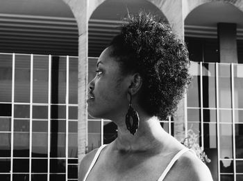 Close-up of young woman with short curly hair