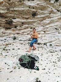 Full length of young man on rock