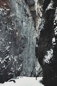 Footpath amidst rock formation during winter