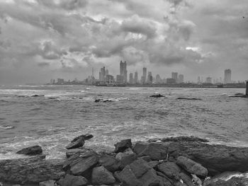 View of calm sea with buildings in background