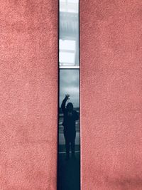 Full length of a woman standing against door