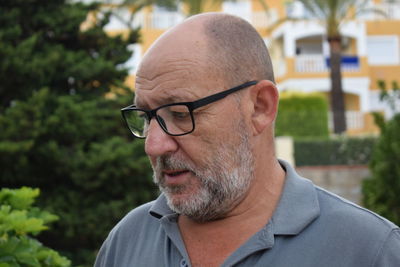 Close-up of mature man wearing eyeglasses while looking down