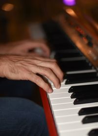 Midsection of man playing piano