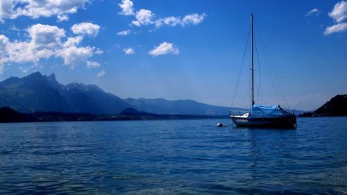 Sailboats sailing in sea against sky