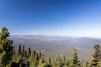 Scenic view of mountains against clear blue sky