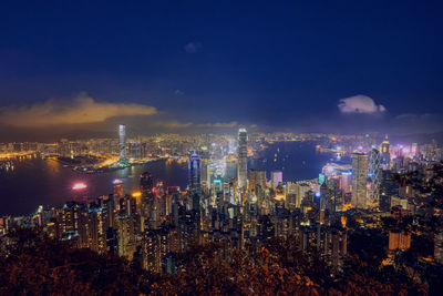 High angle view of illuminated cityscape against sky at night