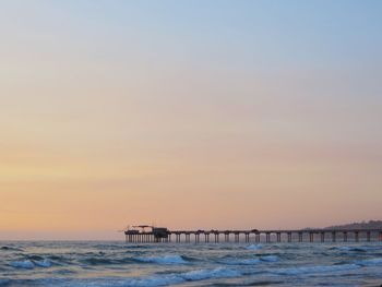 Scenic view of sea against clear sky during sunset