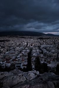 Aerial view of city against cloudy sky