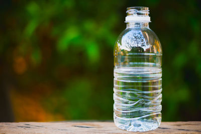 Close-up of water bottle on retaining wall