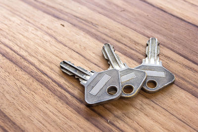 High angle view of keys on wooden table