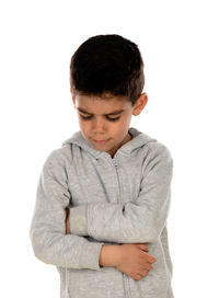 Boy looking away while standing against white background