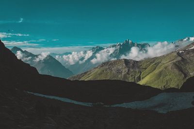 Scenic view of snowcapped mountains against blue sky