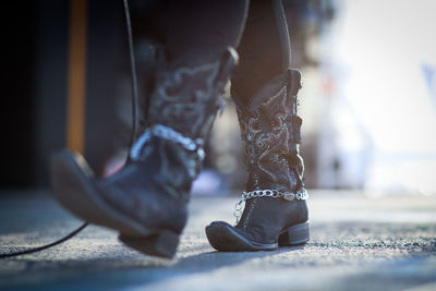 Low section of woman wearing cowboy boots