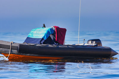 Sailboat in sea against clear sky