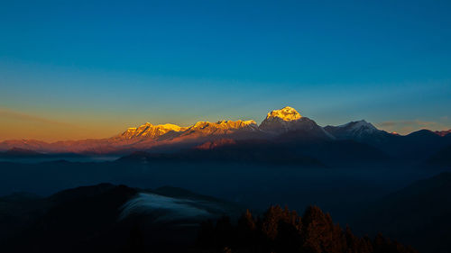 Scenic view of mountains against blue sky