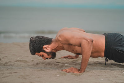 Young man lying on beach