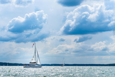 Sailboat sailing on sea against sky