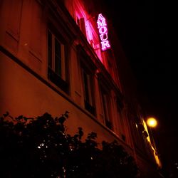 Low angle view of illuminated street light at night