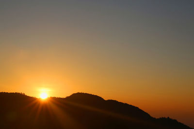 Scenic view of silhouette mountains against sky during sunset