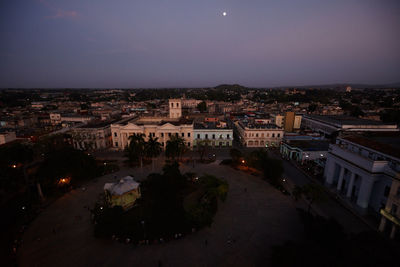 Aerial view of illuminated town against sky at night