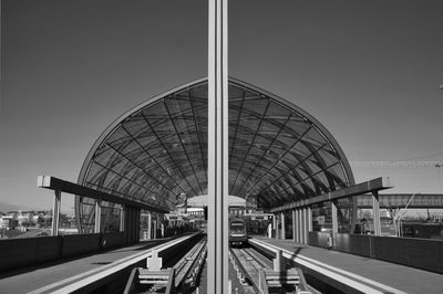 Train at railroad station against clear sky