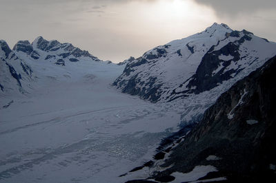 Scenic view of snow covered mountains against sky