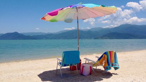 Two lounge chairs on idyllic sunny beach